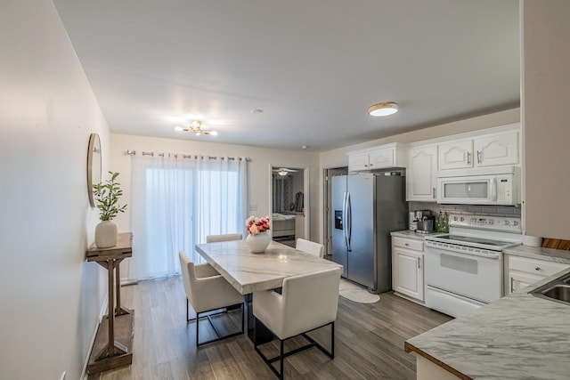 521 Signal Hill Ln, Inman, SC 29349 - kitchen with white appliances, white cabinetry, backsplash, dark wood-style flooring, and a kitchen bar