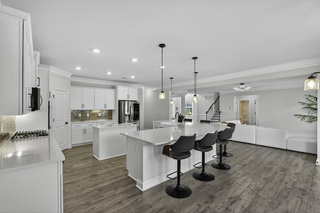 3027 Toliver, Boiling Springs, SC 29316 - kitchen featuring a spacious island, stainless steel appliances, ornamental molding, open floor plan, and dark wood finished floors