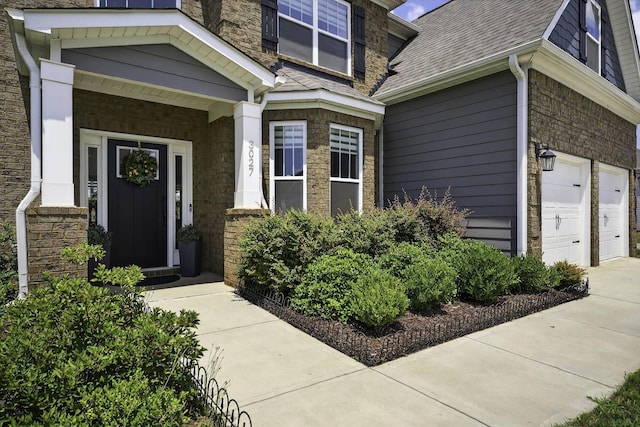 3027 Toliver, Boiling Springs, SC 29316 - entrance to property with stone siding, driveway, a shingled roof, and an attached garage