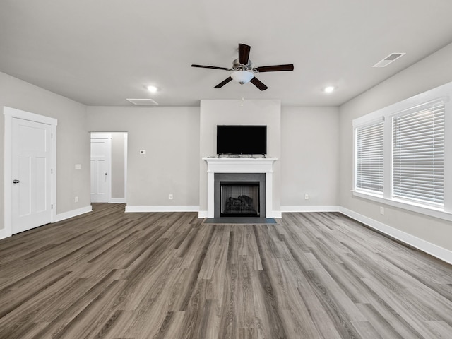 1116 Denington Dr, Spartanburg, SC 29307 - unfurnished living room featuring a ceiling fan, wood finished floors, a fireplace with flush hearth, and recessed lighting