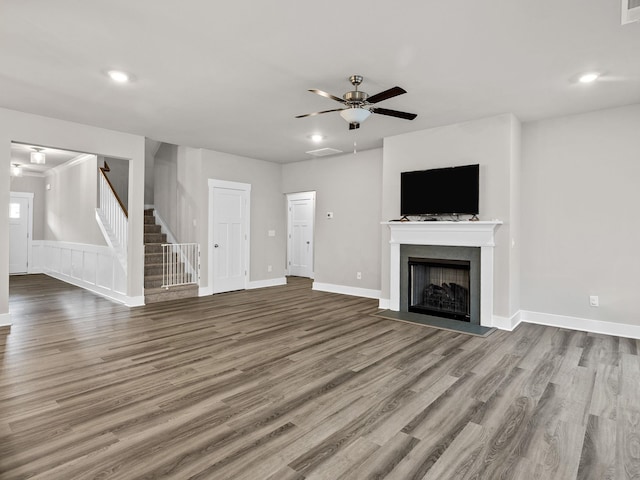 1116 Denington Dr, Spartanburg, SC 29307 - unfurnished living room with a ceiling fan, stairs, wood finished floors, a fireplace with flush hearth, and recessed lighting