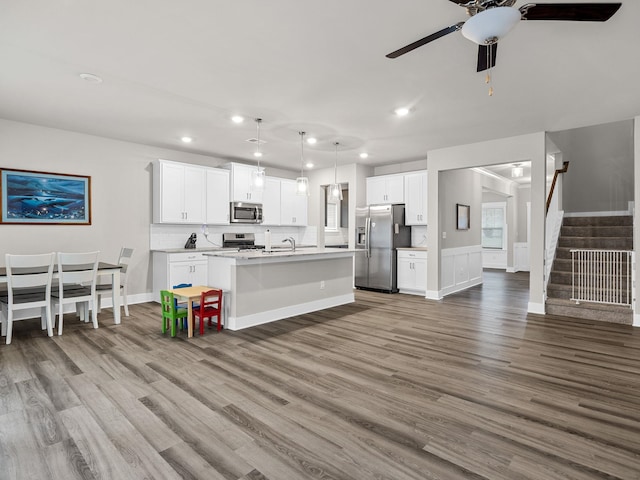 1116 Denington Dr, Spartanburg, SC 29307 - kitchen with appliances with stainless steel finishes, recessed lighting, wood finished floors, a ceiling fan, and an island with sink