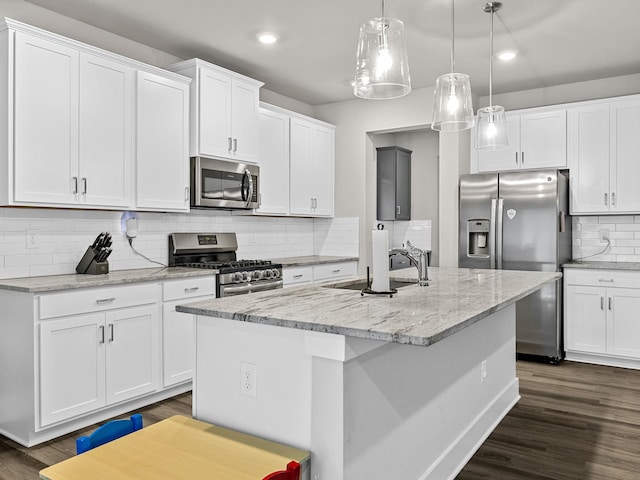 1116 Denington Dr, Spartanburg, SC 29307 - kitchen with stainless steel appliances, backsplash, recessed lighting, an island with sink, and white cabinetry