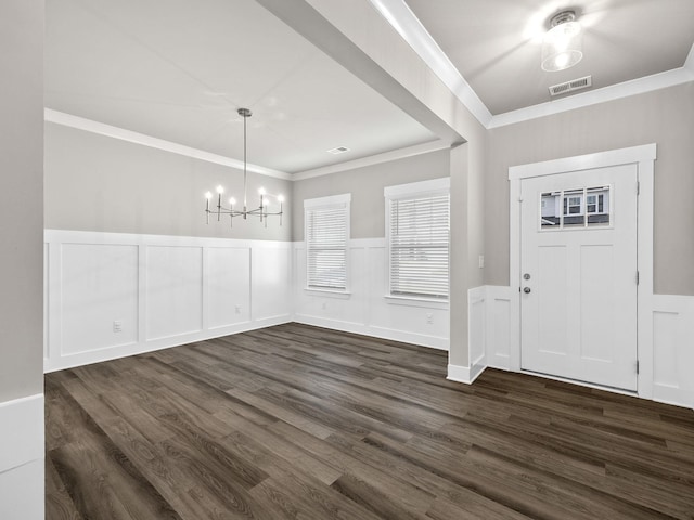 1116 Denington Dr, Spartanburg, SC 29307 - entrance foyer featuring a chandelier, crown molding, wainscoting, dark wood finished floors, and a decorative wall