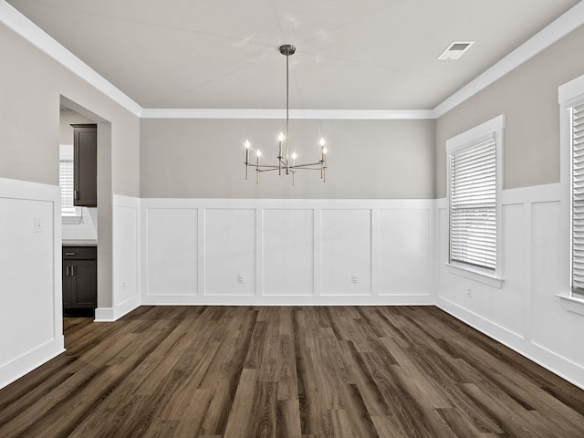 1116 Denington Dr, Spartanburg, SC 29307 - unfurnished dining area with a decorative wall, a chandelier, crown molding, dark wood finished floors, and wainscoting