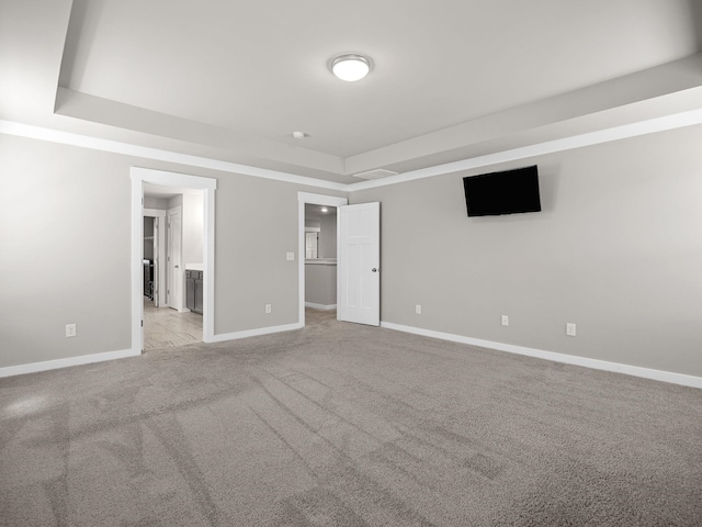 1116 Denington Dr, Spartanburg, SC 29307 - unfurnished bedroom featuring light carpet, a tray ceiling, a walk in closet, and ensuite bathroom