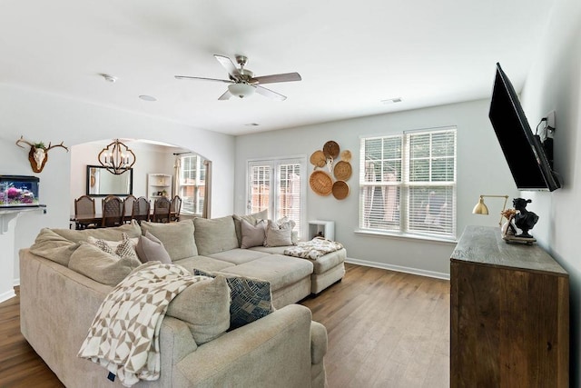 222 Eventine Way, Boiling Springs, SC 29316 - living room featuring arched walkways, wood finished floors, healthy amount of natural light, and ceiling fan