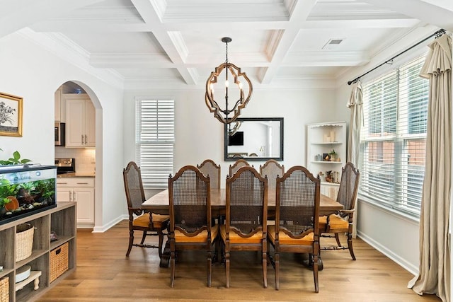 222 Eventine Way, Boiling Springs, SC 29316 - dining room featuring plenty of natural light, light wood finished floors, a chandelier, beamed ceiling, and arched walkways