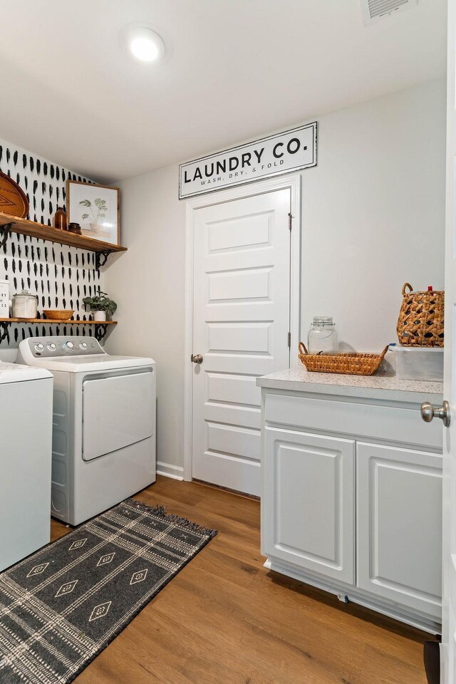 222 Eventine Way, Boiling Springs, SC 29316 - laundry room featuring washer and dryer, wood finished floors, and cabinet space