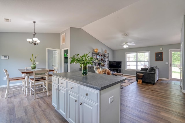 286 Heatherbrook Dr, Lyman, SC 29365 - kitchen with lofted ceiling, wood finished floors, a center island, healthy amount of natural light, and white cabinets