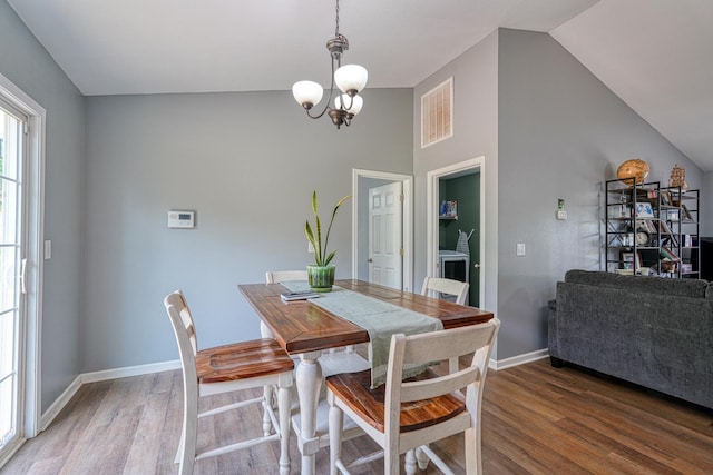 286 Heatherbrook Dr, Lyman, SC 29365 - dining room featuring wood finished floors, vaulted ceiling, and a chandelier