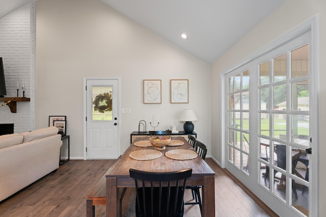 15864 Asheville Hwy, Campobello, SC 29322 - dining area featuring wood finished floors, high vaulted ceiling, recessed lighting, and a brick fireplace