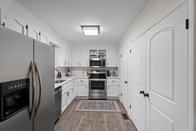 15864 Asheville Hwy, Campobello, SC 29322 - kitchen featuring stainless steel appliances, wood finished floors, white cabinetry, open shelves, and light countertops