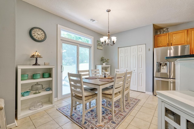 316 Crestview Ln, Spartanburg, SC 29301 - dining area with a chandelier, light tile patterned flooring, and a textured ceiling
