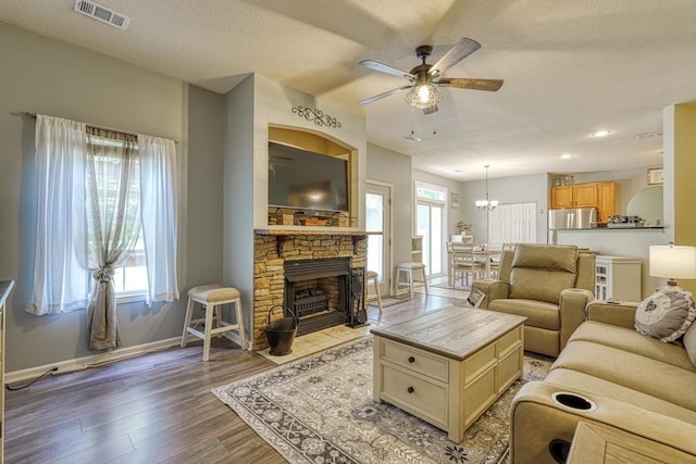 316 Crestview Ln, Spartanburg, SC 29301 - living room with a ceiling fan, light wood finished floors, a textured ceiling, a stone fireplace, and recessed lighting