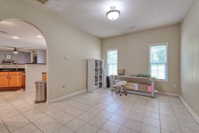316 Crestview Ln, Spartanburg, SC 29301 - home office featuring arched walkways, light tile patterned flooring, a textured ceiling, and ceiling fan