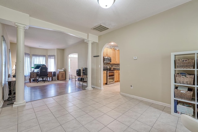 316 Crestview Ln, Spartanburg, SC 29301 - empty room featuring decorative columns, arched walkways, light tile patterned floors, and an office area