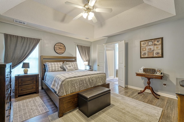 316 Crestview Ln, Spartanburg, SC 29301 - bedroom with multiple windows, wood finished floors, a raised ceiling, and a ceiling fan
