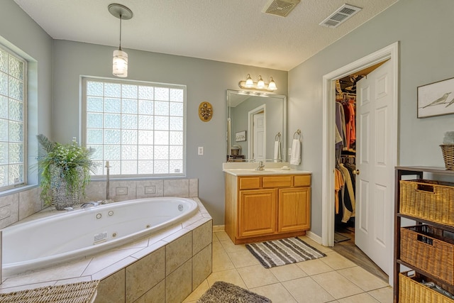 316 Crestview Ln, Spartanburg, SC 29301 - bathroom with vanity, a jetted tub, healthy amount of natural light, tile patterned floors, and a textured ceiling