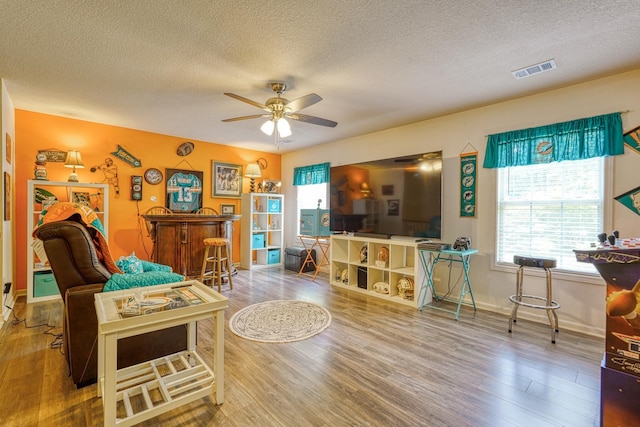 316 Crestview Ln, Spartanburg, SC 29301 - living room with a textured ceiling, wood finished floors, a ceiling fan, and a bar