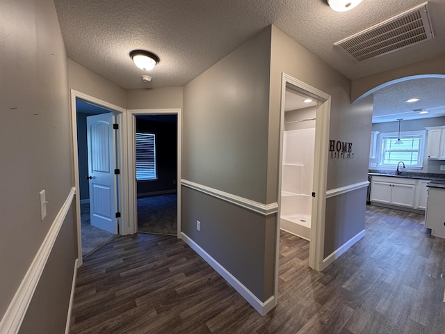 313 Trail Crossing Ln, Inmann, SC 29349 - corridor featuring a textured ceiling, dark wood-style flooring, and arched walkways