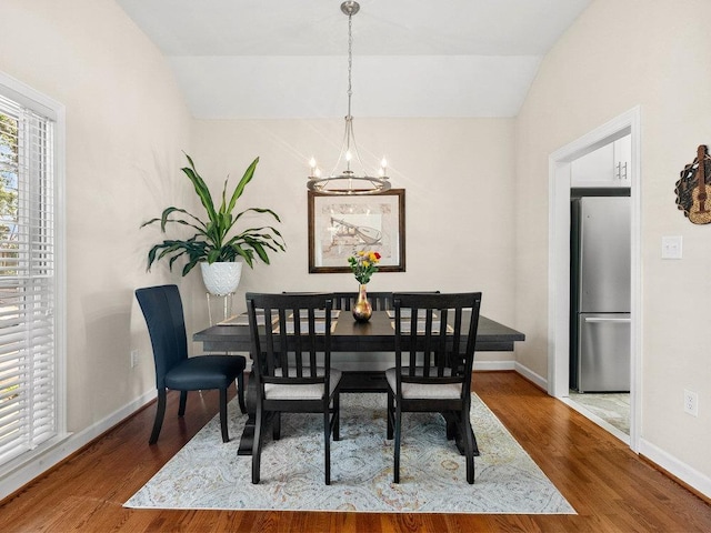 135 N Fairview Ave, Spartanburg, SC 29302 - dining room featuring a chandelier, vaulted ceiling, and wood finished floors
