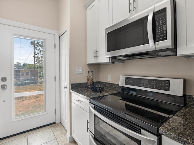 135 N Fairview Ave, Spartanburg, SC 29302 - kitchen with stainless steel appliances, white cabinets, dark stone counters, and light tile patterned floors