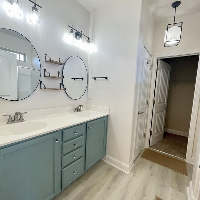240 Stonecrest Dr, Roebuck, SC 29376 - bathroom featuring wood finished floors, double vanity, and a closet