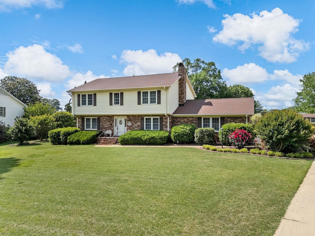 107 Forestdale Dr, Boiling Springs, SC 29316 - colonial home featuring a front lawn, a chimney, and brick siding