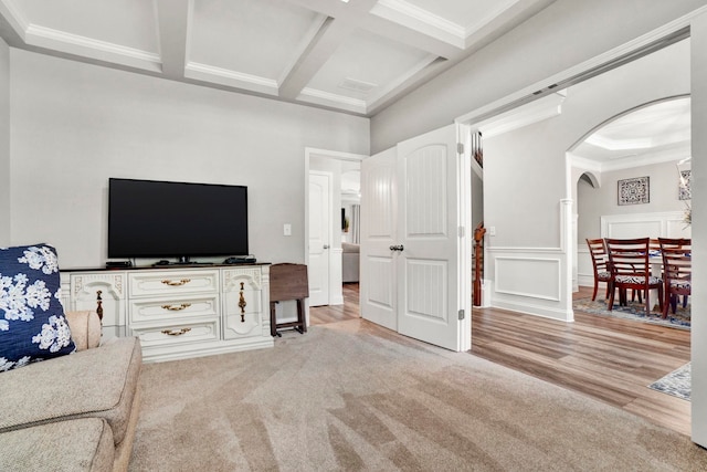 332 Heritage Point Dr, Simpsonville, SC 29681 - carpeted living room with ornamental molding, beam ceiling, coffered ceiling, arched walkways, and wood finished floors