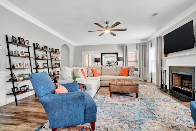 332 Heritage Point Dr, Simpsonville, SC 29681 - living area with ceiling fan, crown molding, wood finished floors, a fireplace with flush hearth, and arched walkways