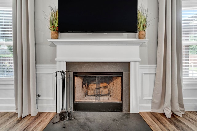 332 Heritage Point Dr, Simpsonville, SC 29681 - detailed view of a fireplace with flush hearth, wood finished floors, and wainscoting