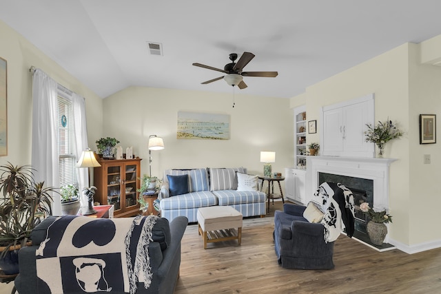360 W Pointe Dr, Spartanburg, SC 29301 - living area featuring a ceiling fan, wood finished floors, a fireplace with raised hearth, and vaulted ceiling
