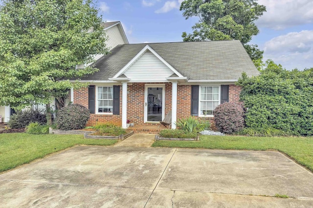 360 W Pointe Dr, Spartanburg, SC 29301 - view of front of home with brick siding, a front yard, and roof with shingles