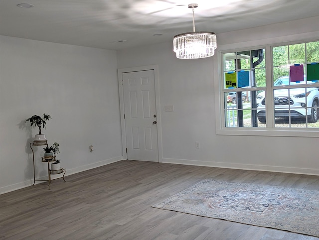 2115 Oakhurst Cir, Spartanburg, SC 29302 - empty room with healthy amount of natural light, a chandelier, and wood finished floors