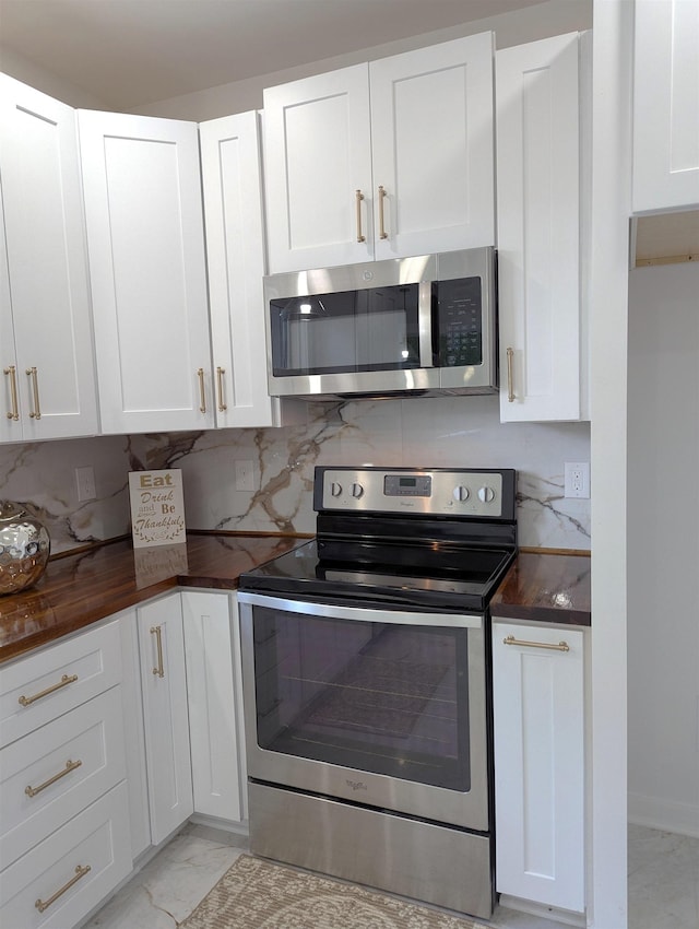 2115 Oakhurst Cir, Spartanburg, SC 29302 - kitchen with appliances with stainless steel finishes, dark countertops, light marble finish flooring, white cabinetry, and tasteful backsplash