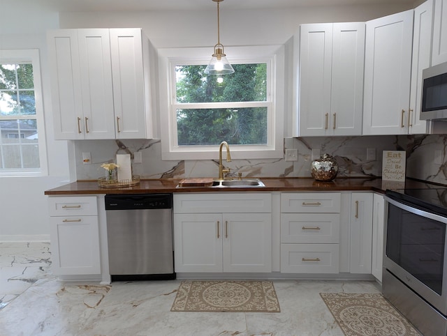2115 Oakhurst Cir, Spartanburg, SC 29302 - kitchen with appliances with stainless steel finishes, light marble finish floors, plenty of natural light, and white cabinets