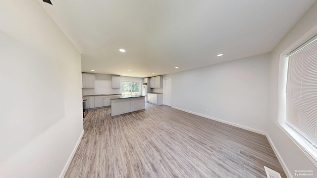 136 Sparkstown Dr, Enoree, SC 29335 - kitchen with light wood-type flooring, recessed lighting, open floor plan, a kitchen island, and freestanding refrigerator