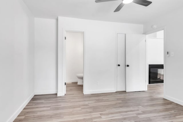 339 Crestview Dr, Spartanburg, SC 29306 - unfurnished bedroom with light wood finished floors, a multi sided fireplace, and ceiling fan