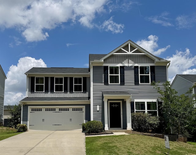 171 Ralston Rd, Greer, SC 29351 - view of front of house featuring a garage, concrete driveway, a front yard, and board and batten siding