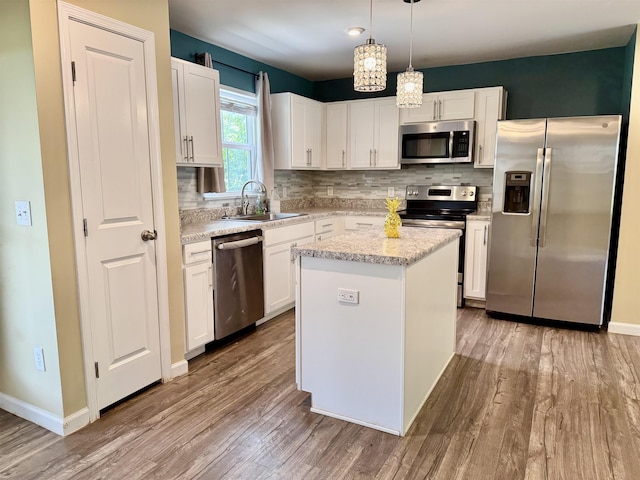 171 Ralston Rd, Greer, SC 29351 - kitchen with appliances with stainless steel finishes, wood finished floors, backsplash, and white cabinets