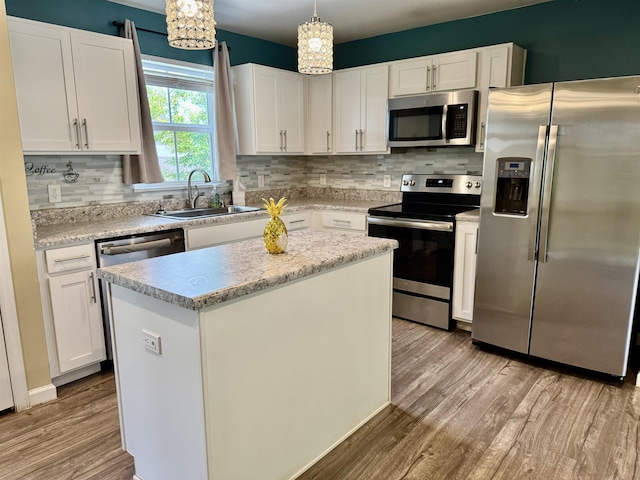 171 Ralston Rd, Greer, SC 29351 - kitchen featuring stainless steel appliances, light wood-style floors, decorative backsplash, and white cabinetry