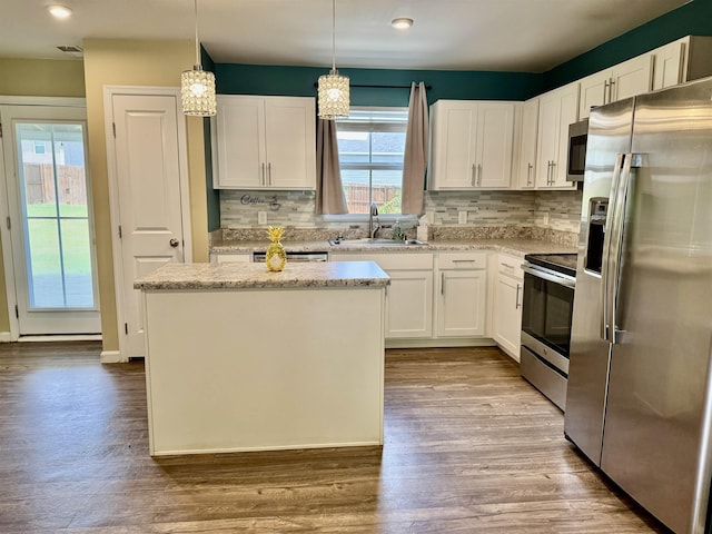 171 Ralston Rd, Greer, SC 29351 - kitchen featuring appliances with stainless steel finishes, white cabinets, a kitchen island, decorative backsplash, and recessed lighting
