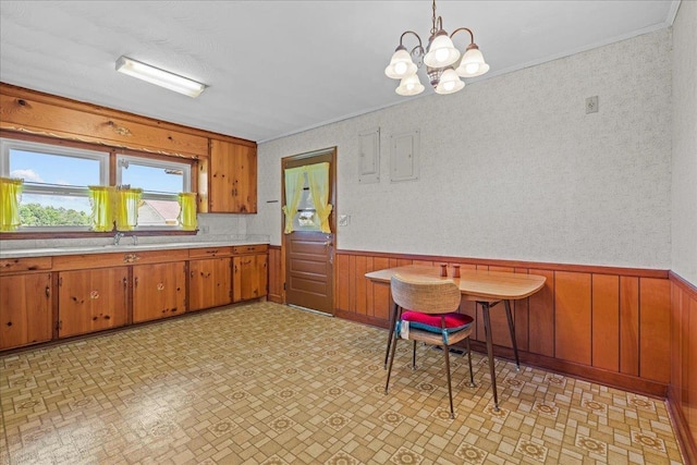 2160 Compton Bridge Rd, Inman, SC 29349 - kitchen featuring light countertops, brown cabinets, a wainscoted wall, a chandelier, and wood walls