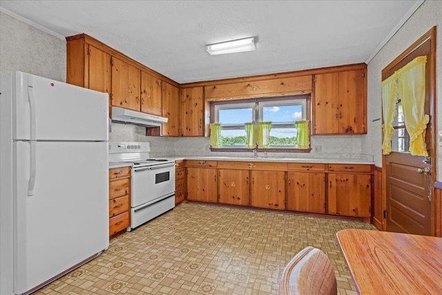 2160 Compton Bridge Rd, Inman, SC 29349 - kitchen featuring white appliances, light countertops, crown molding, and brown cabinetry