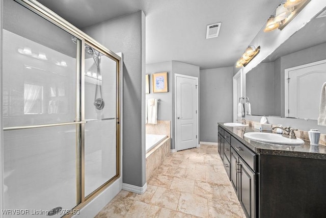 bathroom featuring shower with separate bathtub and vanity