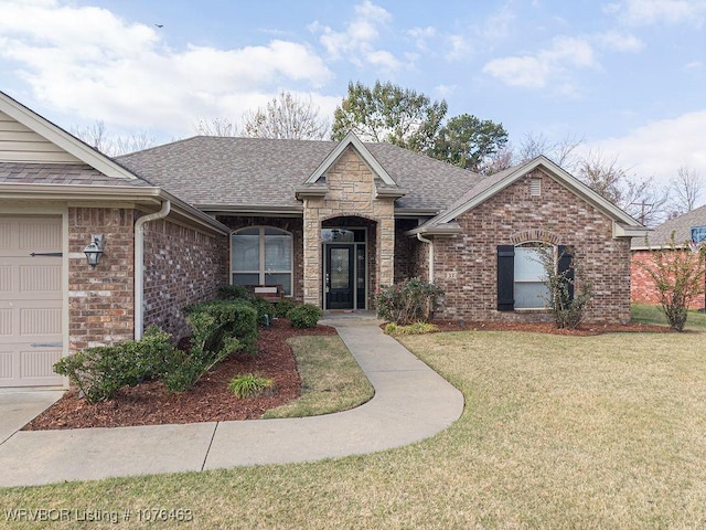 view of front facade with a front lawn and a garage