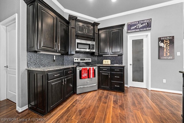 kitchen featuring dark hardwood / wood-style floors, crown molding, appliances with stainless steel finishes, and tasteful backsplash