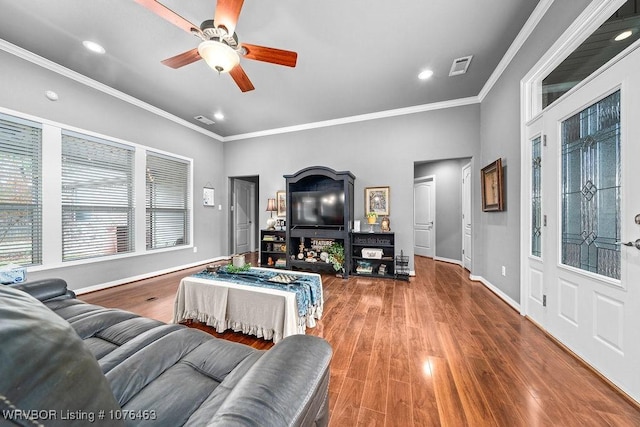 living room featuring hardwood / wood-style floors, ceiling fan, and ornamental molding