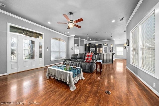 living room featuring crown molding, dark hardwood / wood-style flooring, and ceiling fan